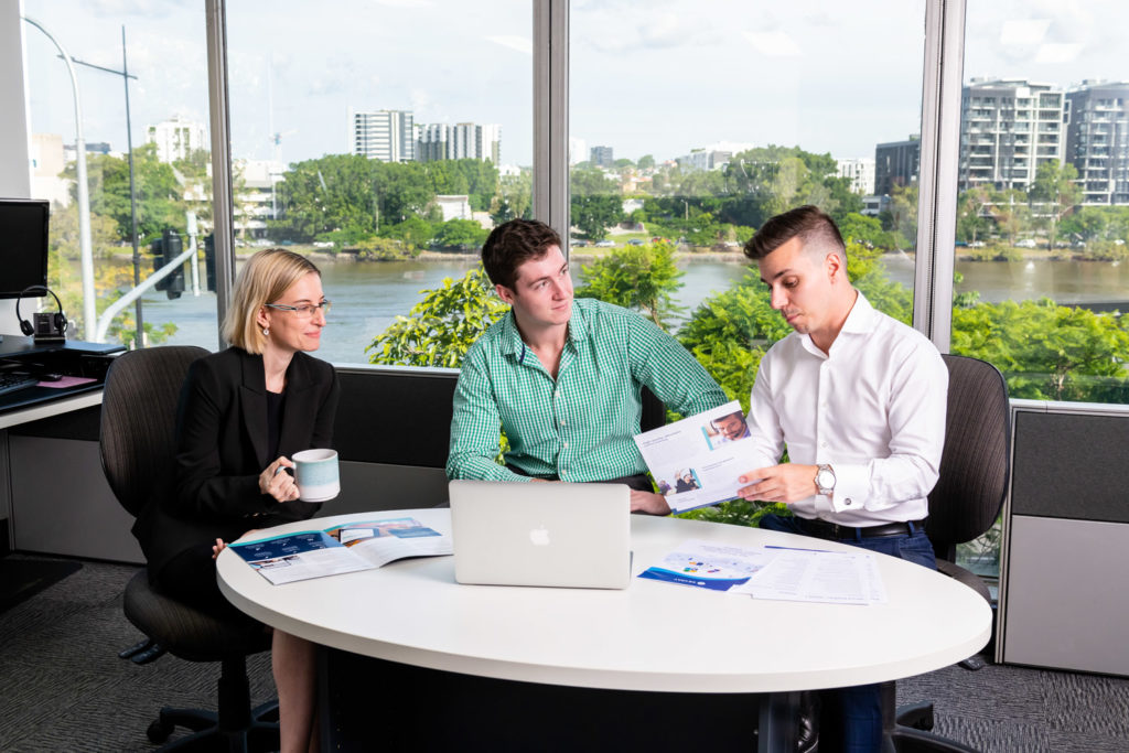 Three Scout Talent recruitment professionals discussing recruitment strategy